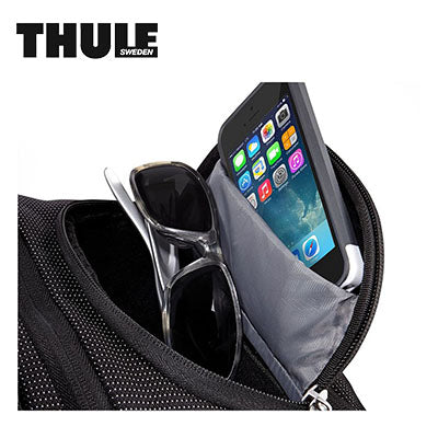 Thule Crossover 25L Laptop Backpack featuring a pocket for sunglasses and smartphone.