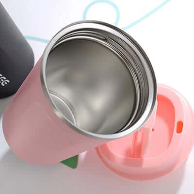 Interior view of a Stainless Steel coffee Thermo Mug with pink exterior and lid.