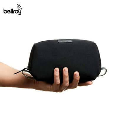 Bellroy Dopp Kit held in hand, showcasing its sleek design and nylon grab loops for easy transport, ideal for corporate gift.