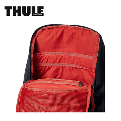 Interior view of Thule EnRoute 18L Backpack showcasing red lining and organized compartments.
