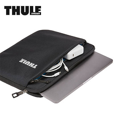 Thule Subterra MacBook® Sleeve 13" in black with charging cables and laptop, ideal for corporate gifts.