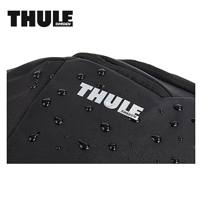 Thule Chasm 26L Backpack showing weather-resistant fabric with droplets of water.