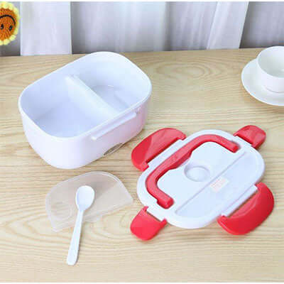 Electric Food Warmer Lunch Box with compartments and spoon on a wooden table.