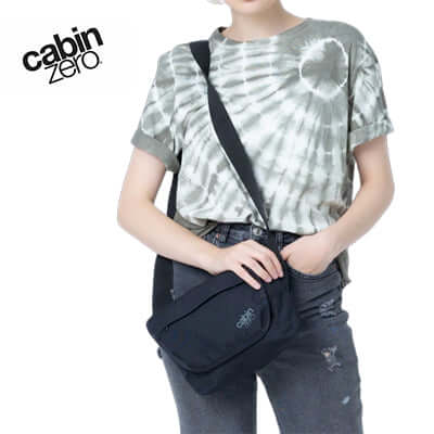 Person wearing the Cabinzero Flapjack Shoulder Bag 4L in black, perfect for daily use and travel.