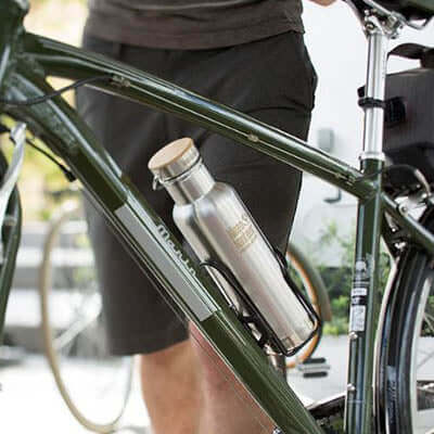 Klean Kanteen Insulated Reflect Stainless Steel Bottle mounted on a bike frame, showcasing eco-friendly design.