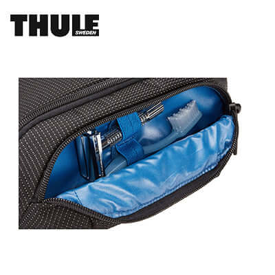 Thule Crossover 2 Toiletry Bag interior showing organized toiletries and mesh pocket for travel convenience.