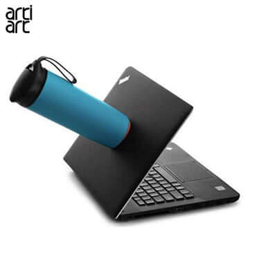 artiart Classic Spill Free Suction Bottle positioned on a laptop, showcasing its spill-proof design for office use.