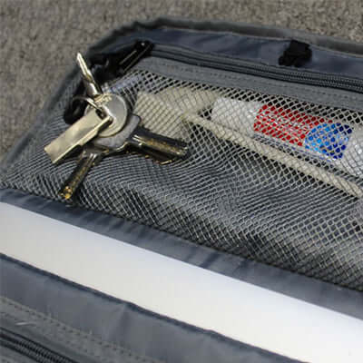Interior view of the BrandCharger Marco Polo Toiletry Bag showing keys and toiletries organized in a mesh pocket.