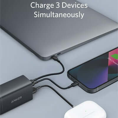 Anker PowerPort III 3-Port 65W charging three devices simultaneously including laptop and phone.