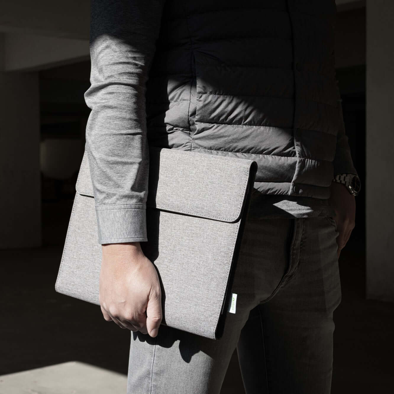 A person holding the BrandCharger Eco Noty Folio, showcasing its stylish design and eco-friendly material.