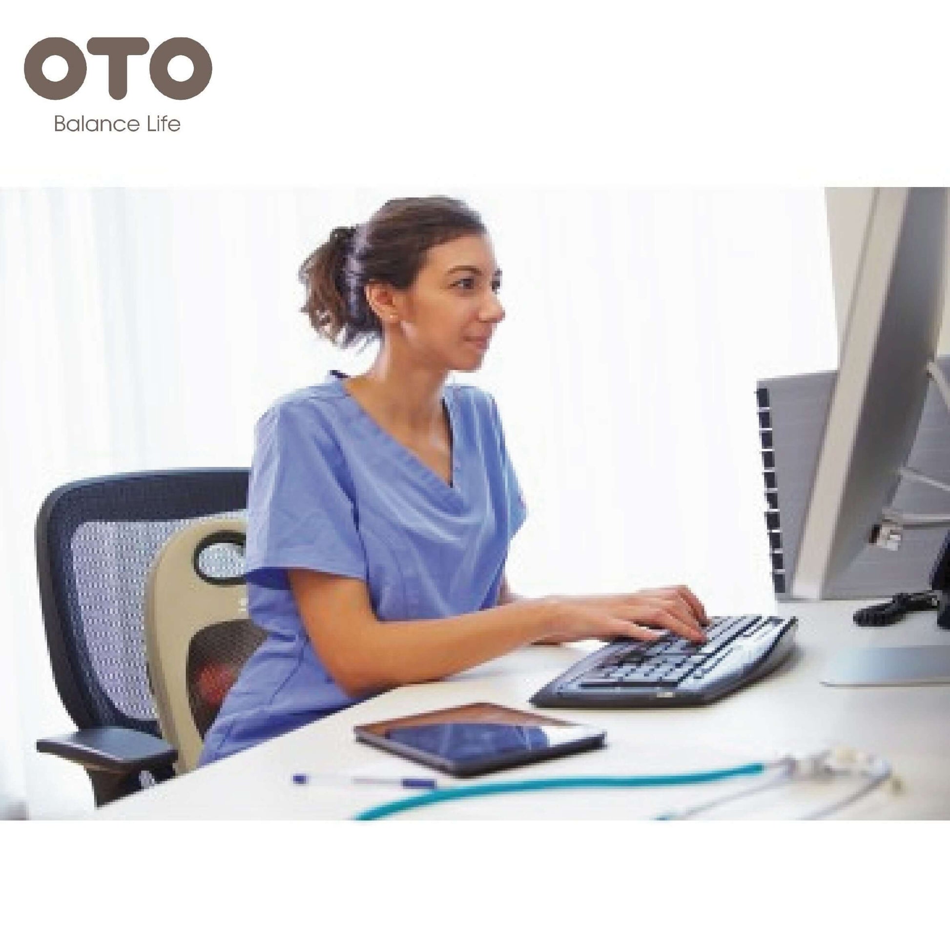 A woman in scrubs using a computer at her desk with the OTO logo in the corner, promoting relaxation and wellness.
