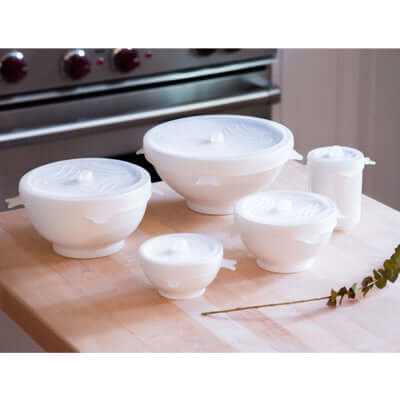 Storage Lid Set displayed on a kitchen countertop, featuring various sizes for versatile food storage.