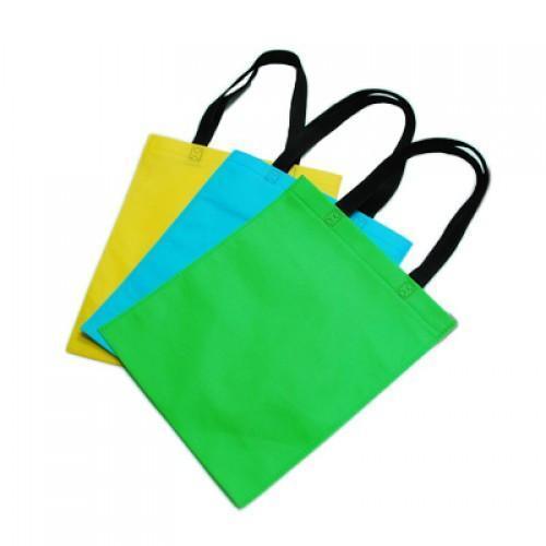 Non-Woven Bag with sturdy handle in yellow, blue, and green colors, perfect for eco-friendly carrying.