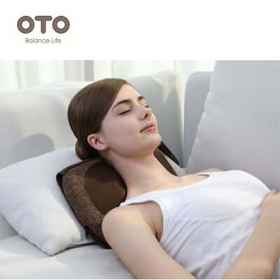 Woman relaxing with OTO Back & Neck Relaxation Clutch on a couch, highlighting comfort and relaxation.