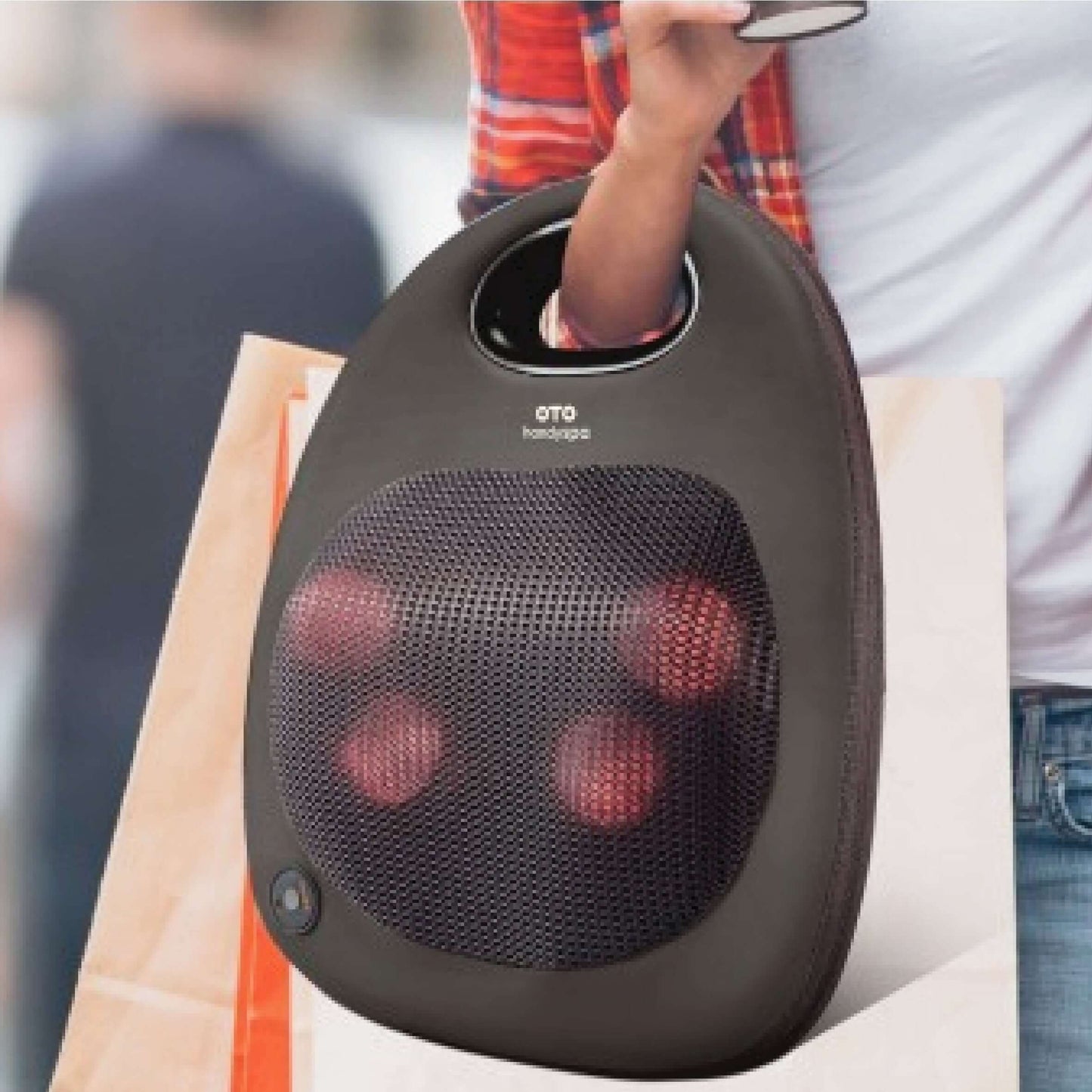 OTO Handy Spa portable massager held in a bag, ideal for relaxation and as a corporate gift.