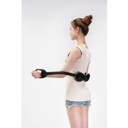 Woman using OTO Neck Spa portable massage tool for relaxation and relief.