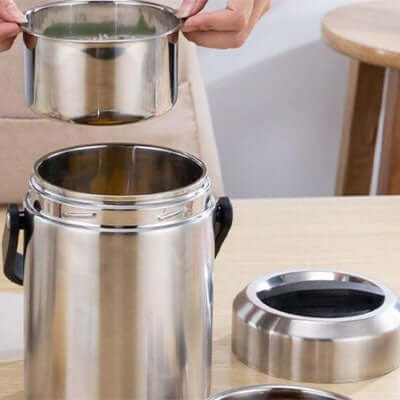 User interacting with 1600ml Stainless Steel Thermal Bento Box for food storage.